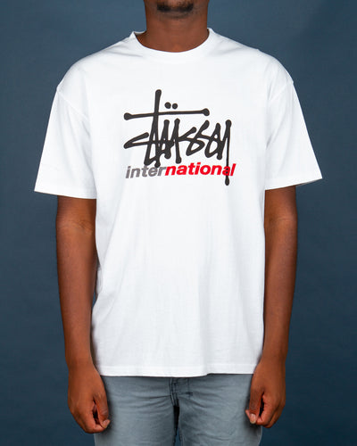 Need a new short sleeve t-shirt in your rotation? The Stussy International Tee in white is made from soft cotton and features a comfortable ribbed neckline. Made in a relaxed fit with a double-stitched hem and short sleeves, this white t-shirt is detailed with a Stussy International graphic on the centre front.